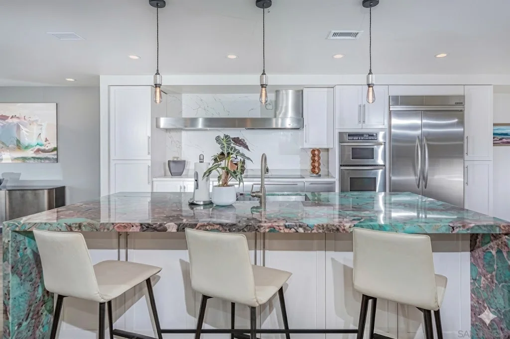 Electrician installing lighting fixture in kitchen