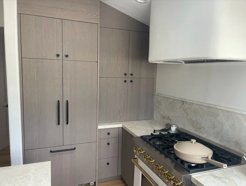 Modern kitchen with white cabinets, granite countertops, and stainless steel appliances