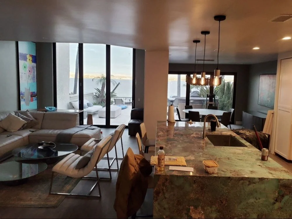 Bright open-concept living space with stylish pendant lighting installed by Emerald C Construction in a Vista California home, showcasing modern lighting upgrades and warm ambient illumination.