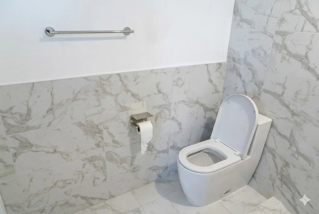 Modern wall-mounted toilet with Carrara marble tile walls and floor